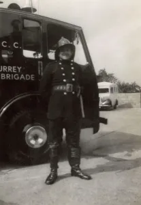 London Fire Brigade: Firefighter posing proudly by LCC LFB vehicle