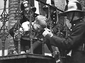 Expander: Firefighter using railing expander to release boy