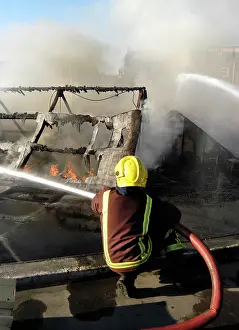 Hosing: Firefighter working at scene of fire at New Cross
