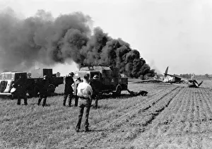 Ploughed: Firefighters attending crashed plane in field, WW2
