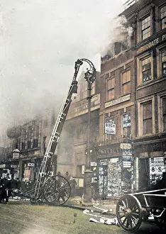 Ladders: Firefighters attending a fire in the Strand in London