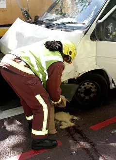 Crumpled: Firefighters inspecting a broken down Ford transit van