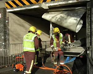 Norbury: Firefighters working to remove van trapped under bridge