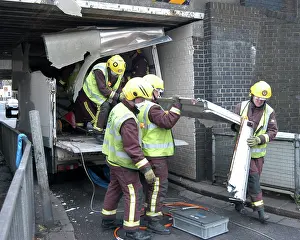 Norbury: Firefighters working to remove van trapped under bridge