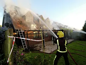 Firefighters working at scene of domestic fire, Harrow