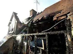 Charred: Firefighters working at scene of domestic fire, Harrow