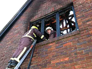 Charred: Firefighters working at scene of domestic fire, Harrow