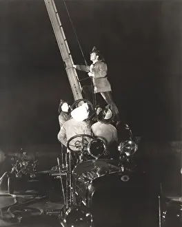 Firetruck: Firemen raising ladder on firetruck