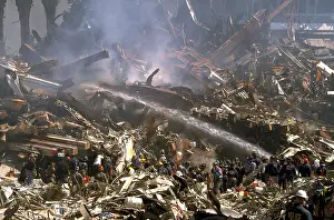 Nyfd: Firemen sprays still burning ruins of the World