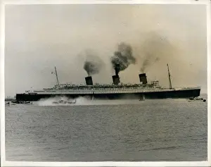 Hovercraft: First hovercraft dwarfed by liner Queen Mary