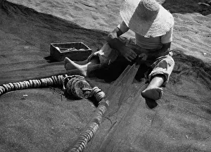 Mends: Fisherman mends a net