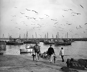 Waders: Fishermen and boats in a harbour