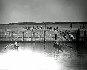 Angling: Fishing from a harbour wall, India
