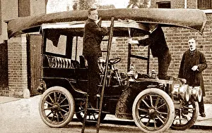 Fixing: Fixing a canoe to the top of a veteran car, early 1900s