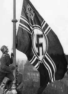 Refoundation: Flag hoisting over the barracks of a Flak regiment in Be