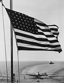 Lcgr1509: Flag of the United States snaps in the breeze over