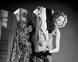 Provocative: Flirting Woman Peeking Around from Behind Dressing Screen