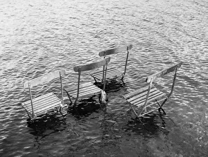 Ripples: Flooded riverbank with chairs