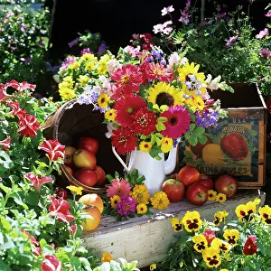 Gerber: Flower arrangement in garden setting with antique