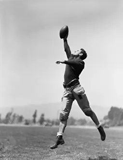 Midair: Football player catching ball