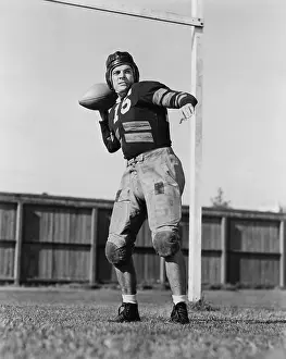 Focused: Football player throwing ball