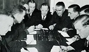 Laws: Football referees studying the rules of the game
