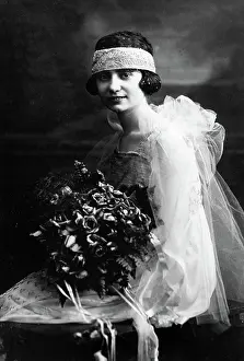 Vows: Formal portrait of bride with bouquet looking
