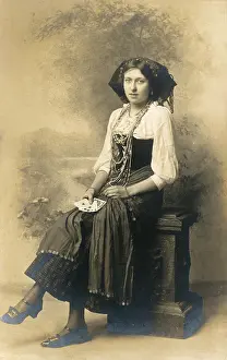 Divination: A fortune teller posing with a handful of cards