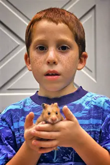 Hamster: Freckle-Faced Boy Holding Pet Hamster in his Hands