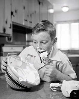 Preteen: Freckled Boy in Kitchen licks clean the Whipping Cream Icing