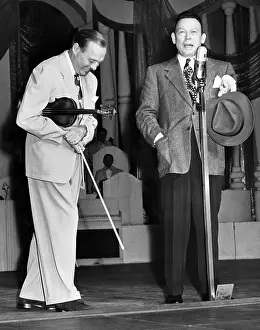 Interrupts: Fred Allen (right) interrupts Jack Benny's ?