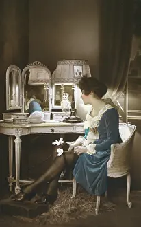Garters: French lady getting ready to go out in her boudoir