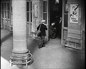Columned: A French Man Carrying a Shoulder Bag is Walking
