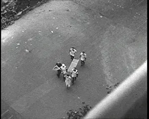 Paramedics: French Paramedics Running Across A Street To