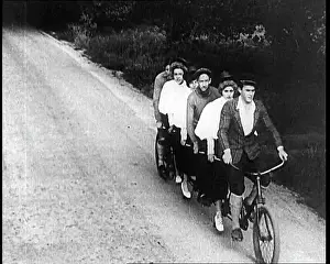 Tandem: French People Riding Tandem Bicycle Down A Road