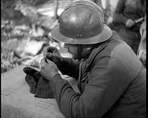 Darning: French Soldier Darning His Socks in a Dug Out