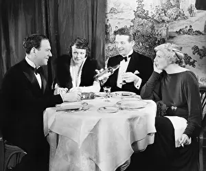 Formalwear: Friends sitting together at a dinner table