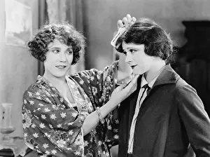Tenderness: Two friends standing together and doing their hair