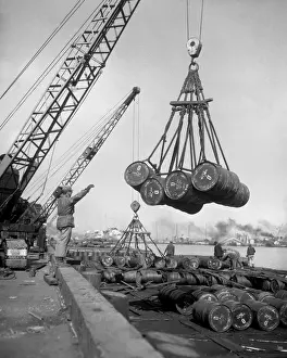 Inchon: Fuel drums are lifted and moved with cranes from
