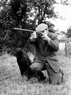 Gamekeeper: Gamekeeper taking aim, his dog at his side