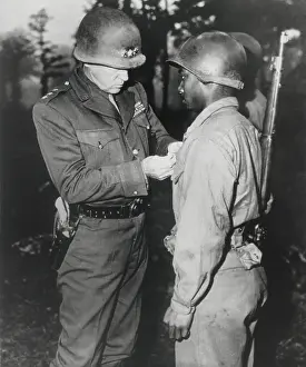 Conspicuous: Gen. George Patton, pins the Silver Star on Private
