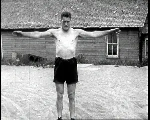 Flexing: Gene Tunney, the Boxer, Flexing His Muscles