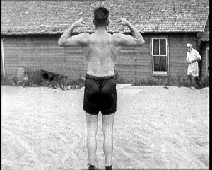 Flexing: Gene Tunney, the Boxer, Flexing His Muscles