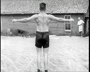 Flexing: Gene Tunney, the Boxer, Flexing His Muscles