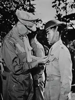 Heroism: General Douglas MacArthur pinning a Distinguished
