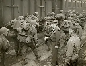 Lcgr1310: General Dwight Eisenhower greets GI's loaded down