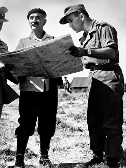 Georgios: General Georgios Grivas looking over a map with soldiers