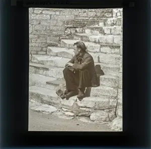 Alex Lambert Lantern Slide Collection: Gentleman sitting on steps