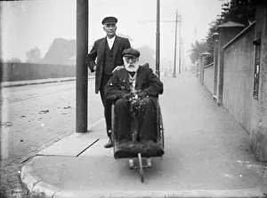 Bathchair: Two gentlemen, one in wheelchair