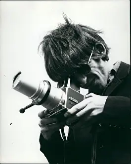 Bridie: George Harrison of The Beatles pop group with camera
